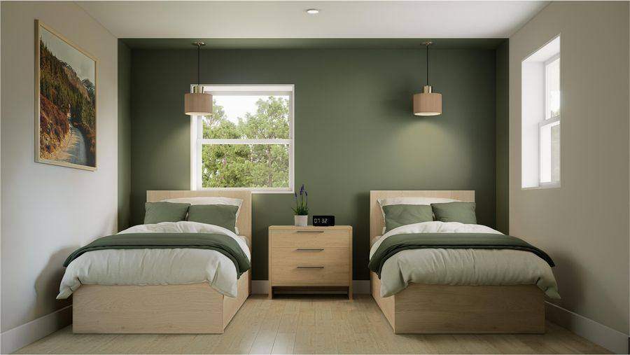 A client bedroom with two beds, a nightstand between them and green walls
